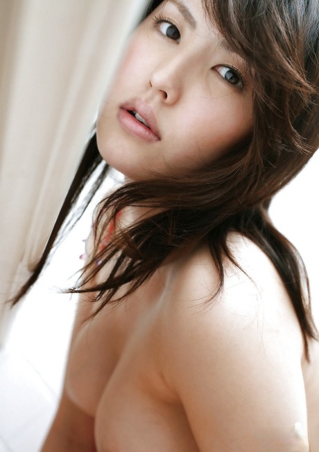 Hot asian babe Takako Kitahara uncovering her big tits and hairy pussy