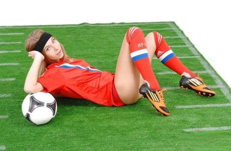 Sporty babe taking off her football outfit and fingering her pussy