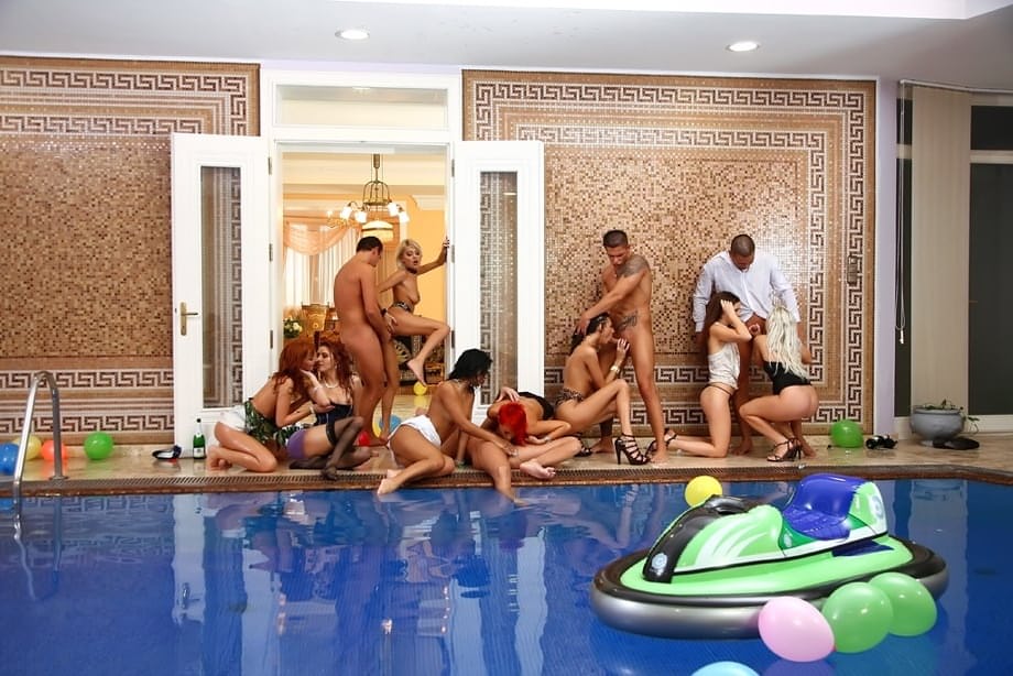 Salacious MILFs enjoy a wild orgy with horny guys at the pool party