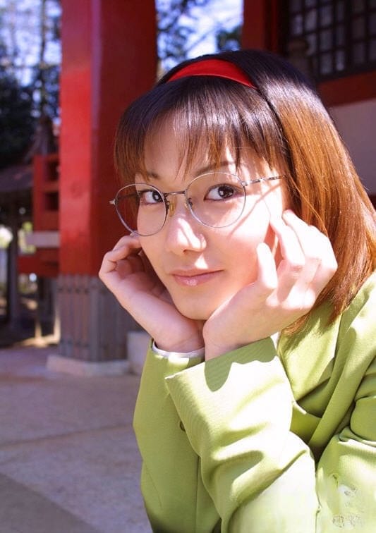 Naughty asian babe in glasses and school uniform revealing her titties