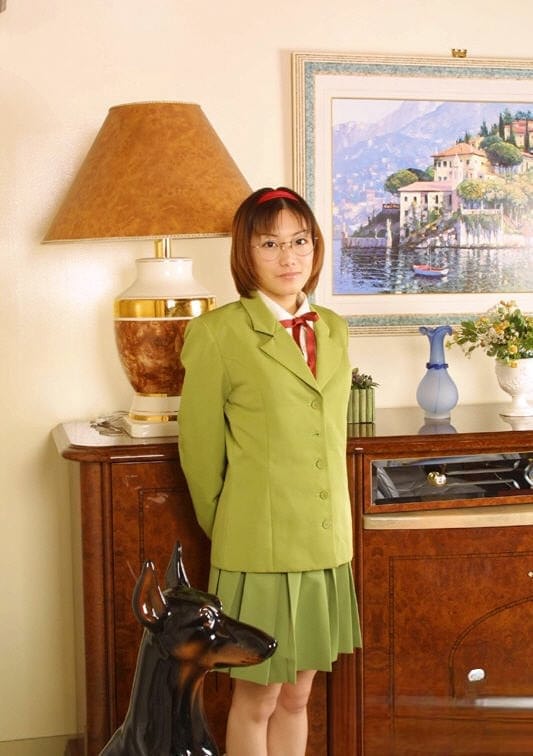 Naughty asian babe in glasses and school uniform revealing her titties