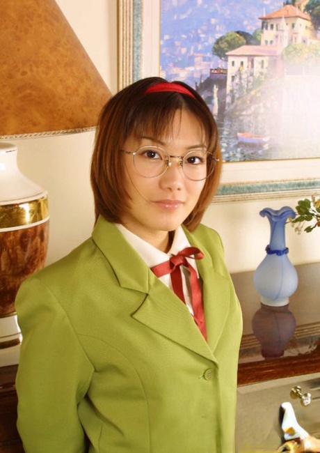Naughty asian babe in glasses and school uniform revealing her titties