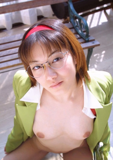 Naughty asian babe in glasses and school uniform revealing her titties