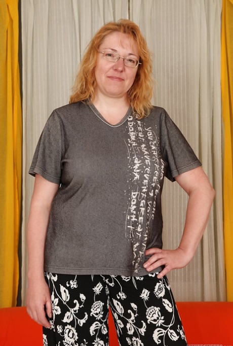 Chubby redhead mature gal with big flabby jugs getting naked
