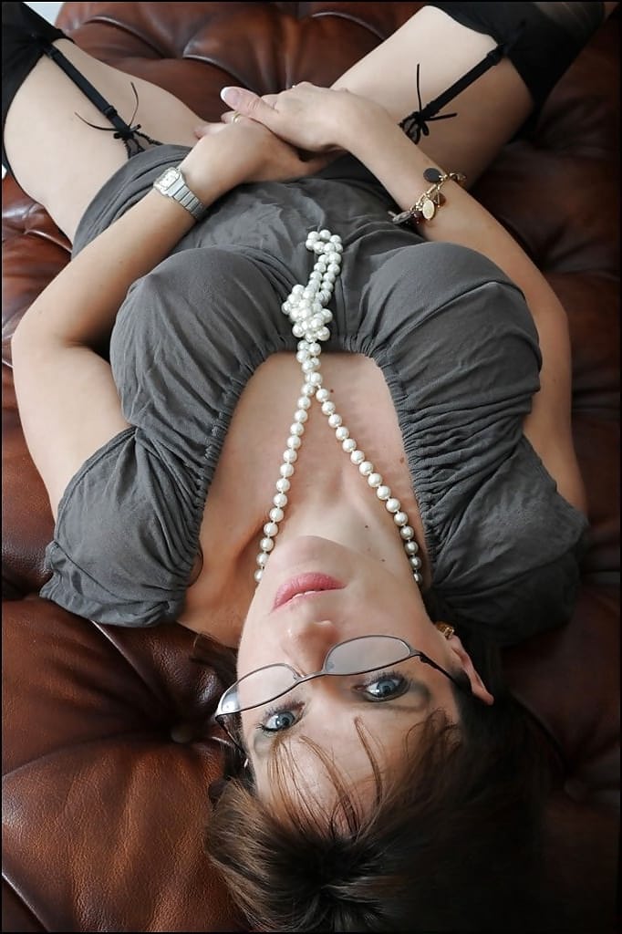 Lustful mature lady in stockings fingering her pink twat