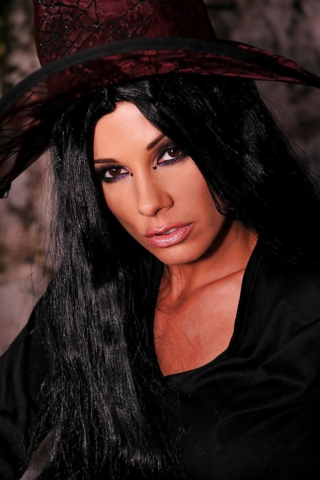 Ravishing pornstar in witch outfit stripping and masturbating her cunt