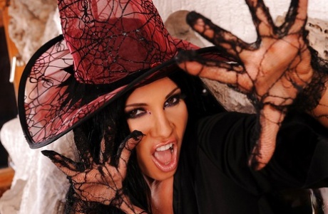 Ravishing pornstar in witch outfit stripping and masturbating her cunt