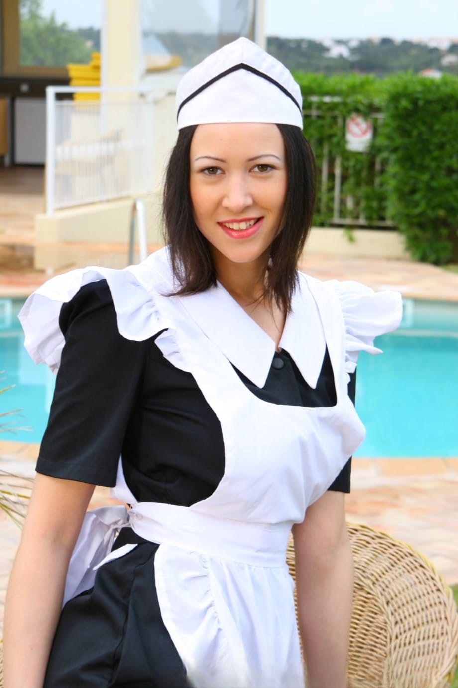 Sexy maid Carole Hunt strips down to her underwear and nylons near a pool