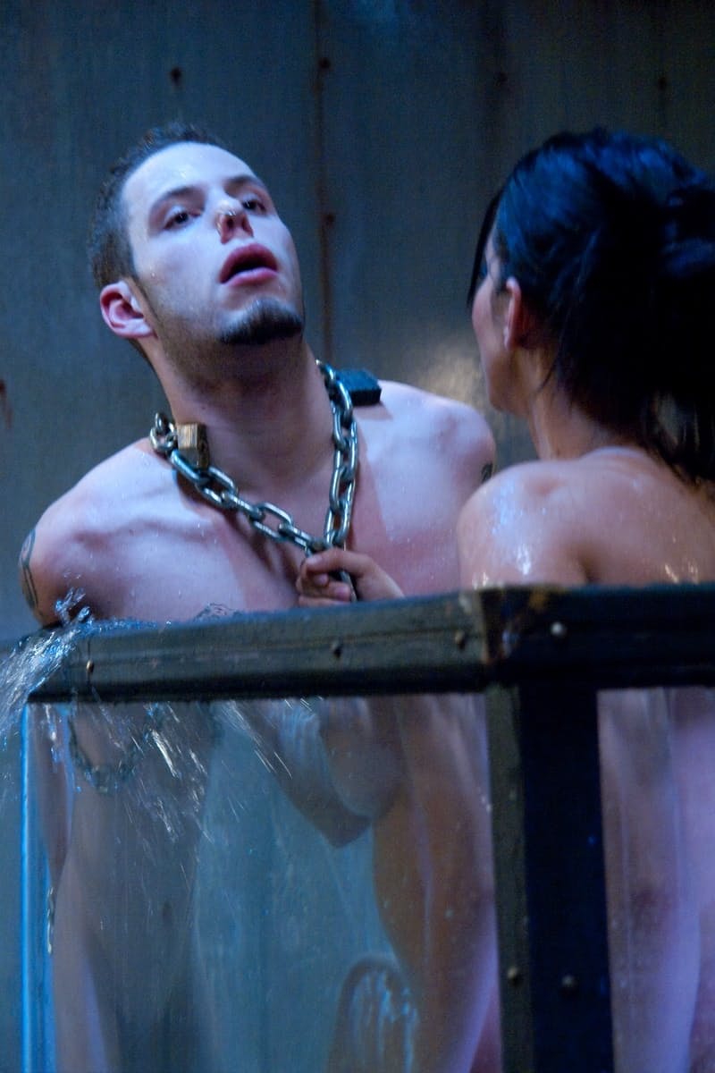 Goddess Isis Love playing with a chained BDSM male sub's cock under the water