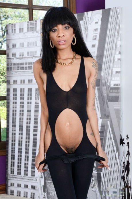 Slim inked ebony September Reign takes off her outfit and spreads her holes