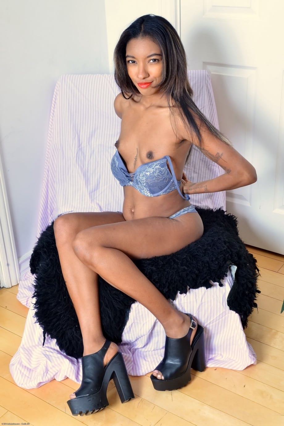 Black babe Raven Wylde exposes her tiny tits and amazing butt in heels