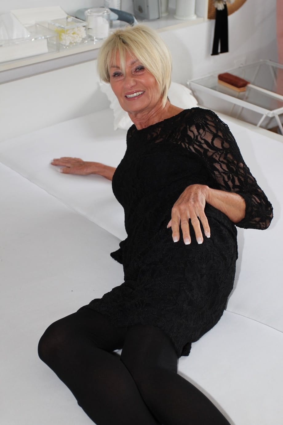 Old blonde woman removes black pantyhose to spread her pussy lips