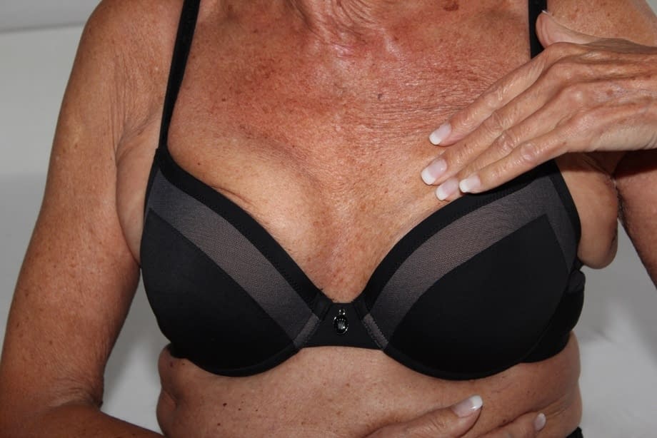 Old blonde woman removes black pantyhose to spread her pussy lips