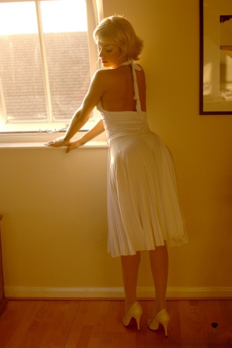 British MILF in a white dress Natasha Marley flashes her panties and stockings