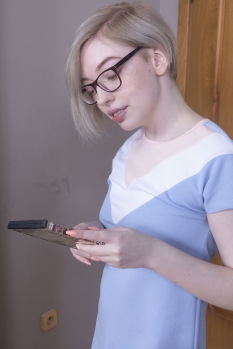 Nerdy teen with blonde hair Abby exposes her bushy clam in a solo
