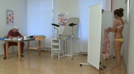 Redheaded teen Lara takes her gyno's stiff rod from behind at the clinic