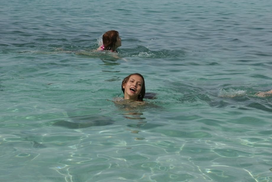 Smoking hot shemale babes going topless and posing in the sea water