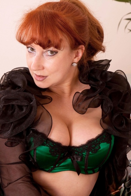 Mature seductress Red posing and masturbating in her sexy lingerie