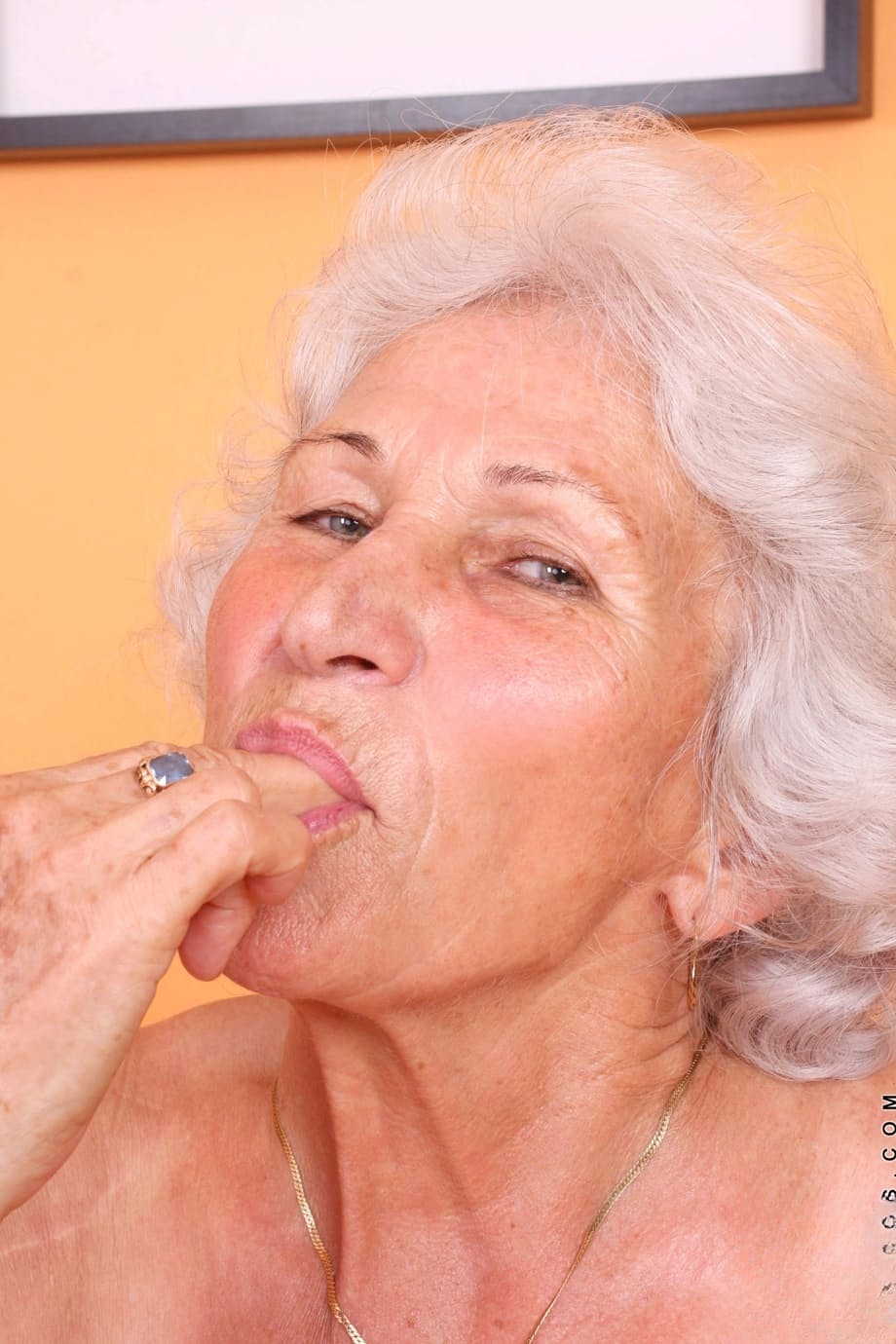 Grey haired granny Betty exposes her saggy juggs and fingers her clam