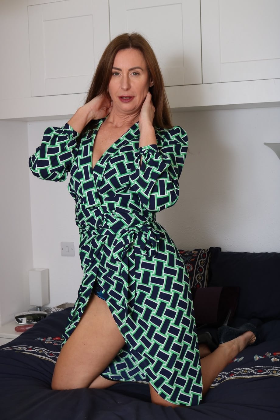 British MILF Lara Latex doffs a robe before masturbating with a red toy