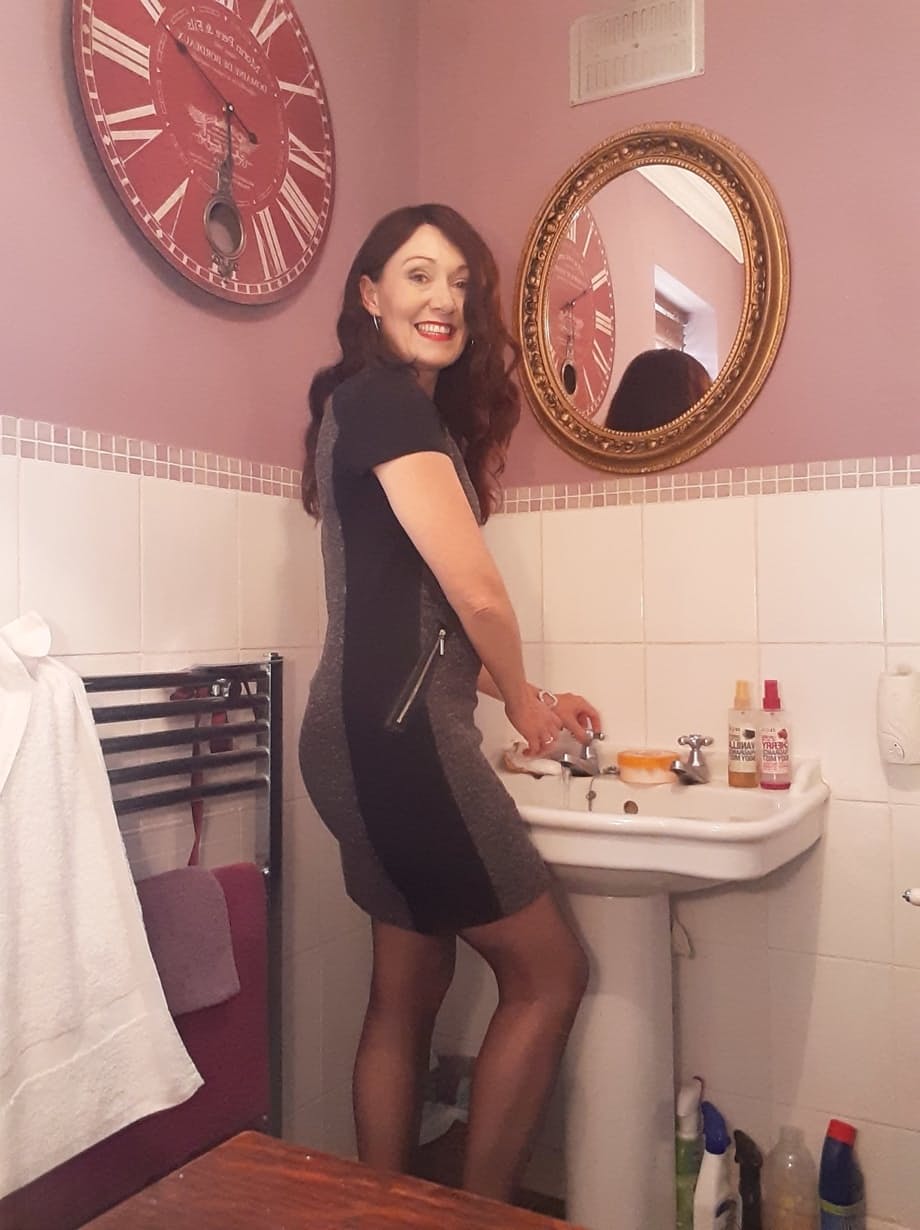 Sexy MILF Kitty Cream models for a non-nude shoot while at home and alone