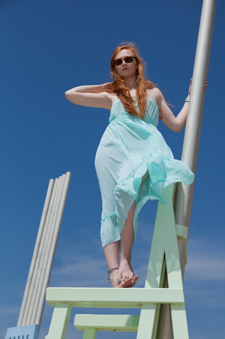 Redhead teen Bree Abernathy goes for a walk outdoors in a see thru dress