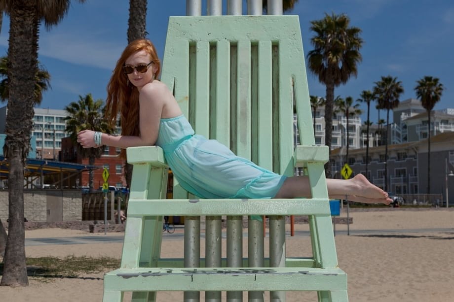 Redhead teen Bree Abernathy goes for a walk outdoors in a see thru dress