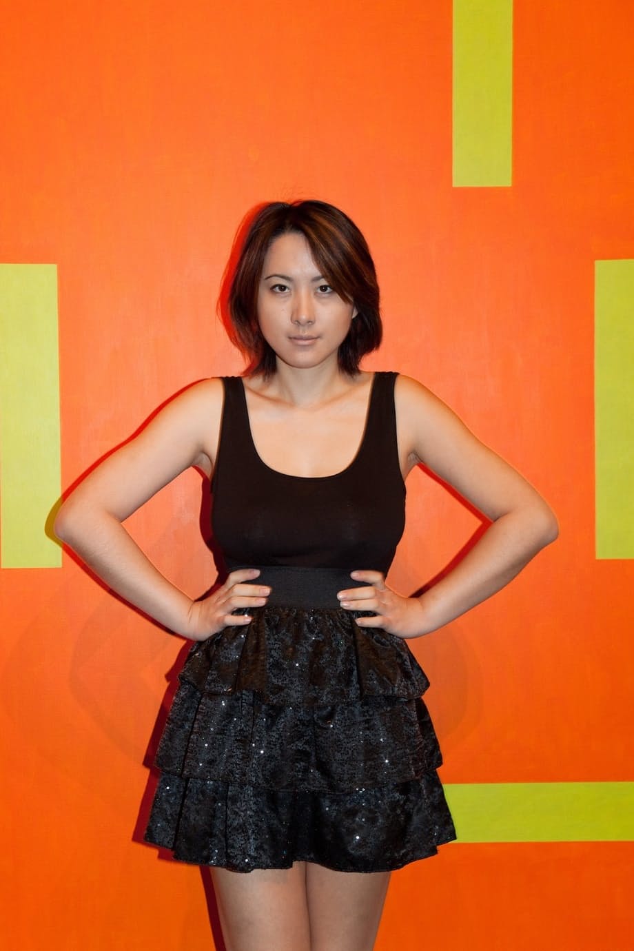 Skinny Chinese babe Li Zheng poses in the black T-shirt and skirt