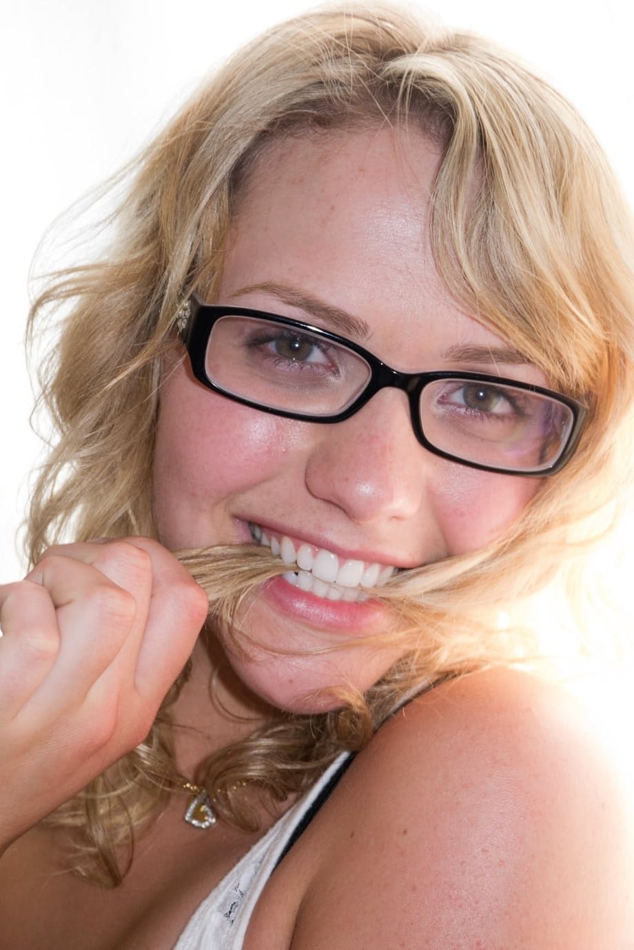 Blonde teen Mia Malkova models non nude in jeans shorts on top of a motorcycle