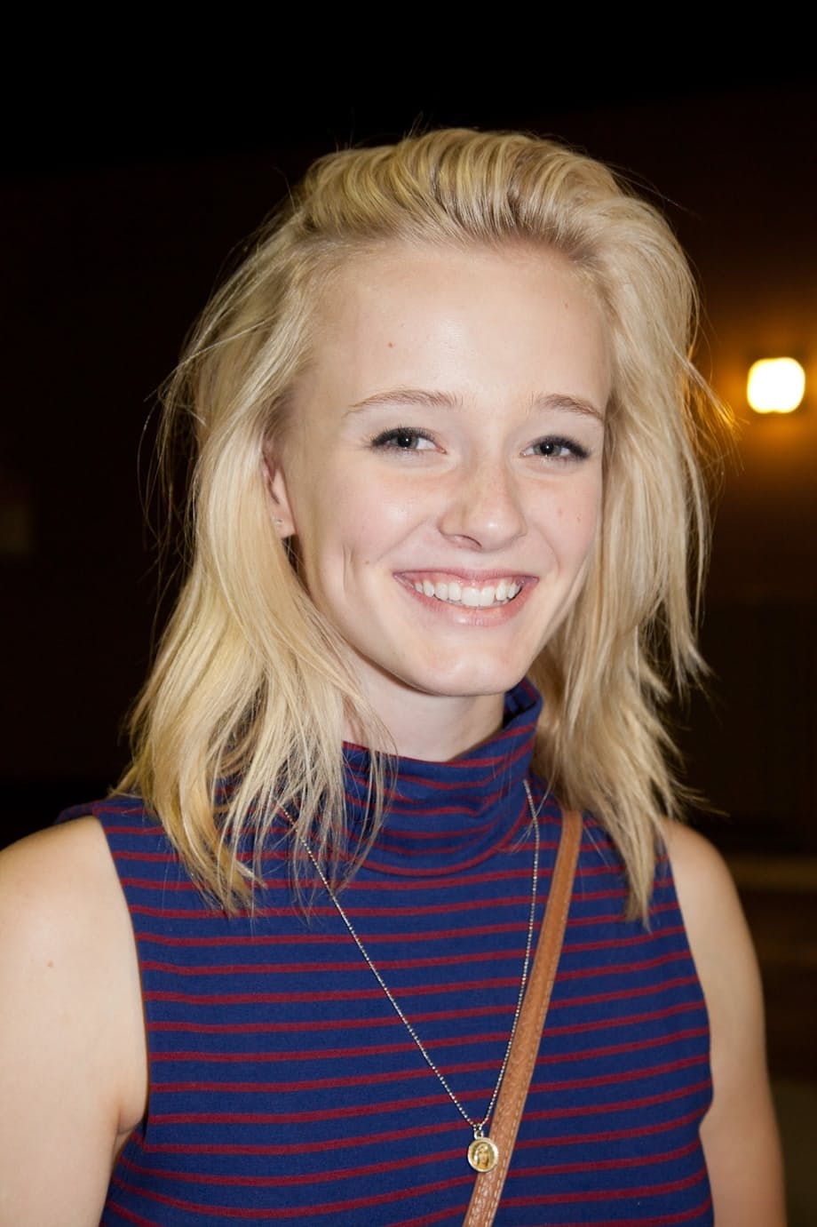 Blonde girlfriend Kenze Thomas hams it up for her boyfriend in a tight dress