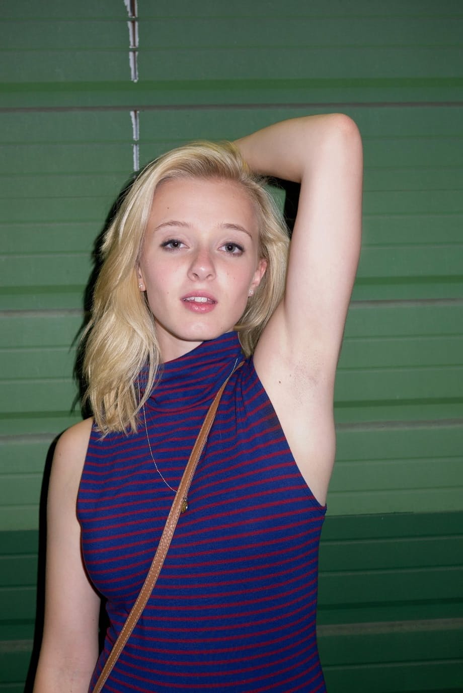 Blonde girlfriend Kenze Thomas hams it up for her boyfriend in a tight dress
