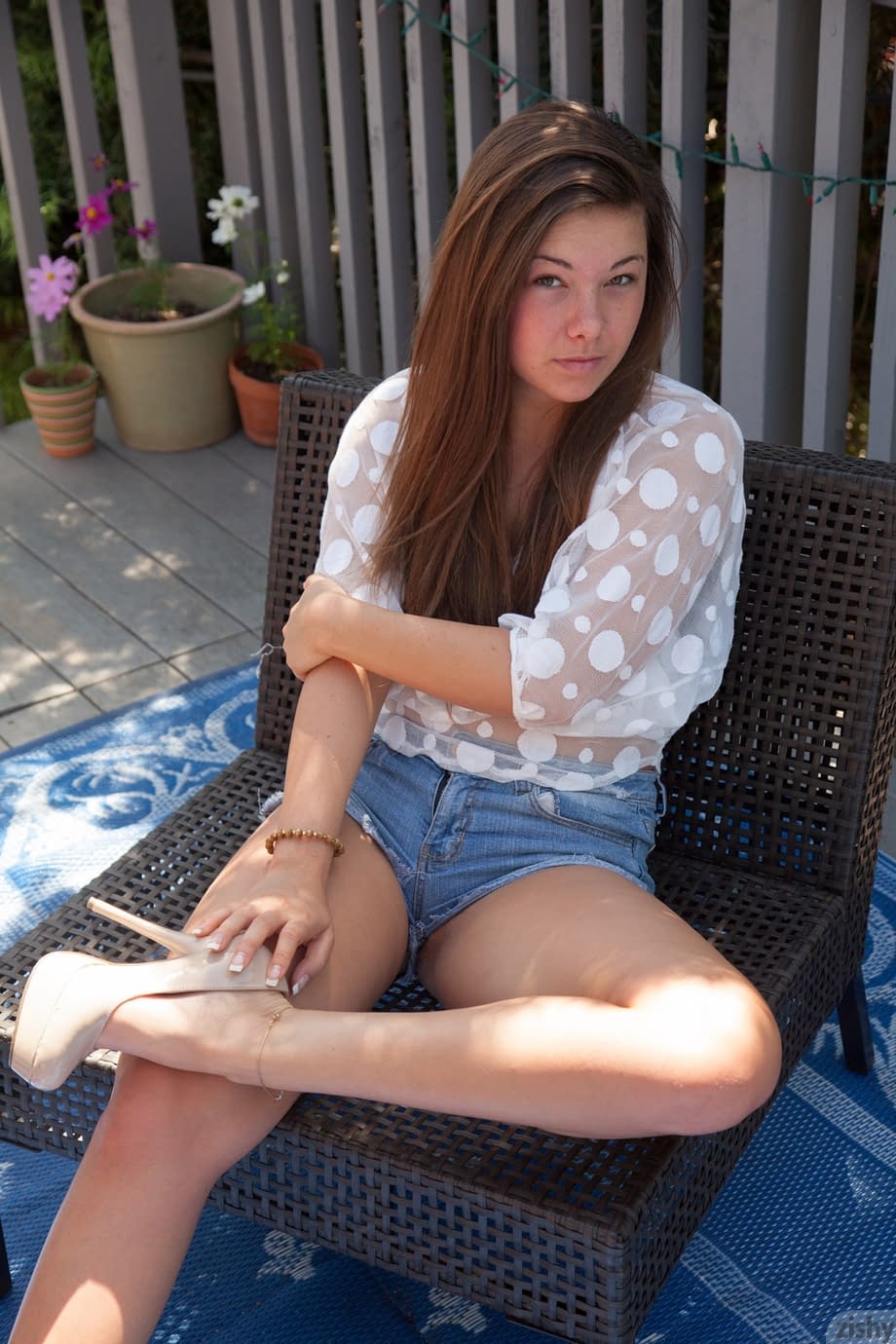 Shapely teen Nikki Yann bares round ass in thong panties & sheer shirt outside