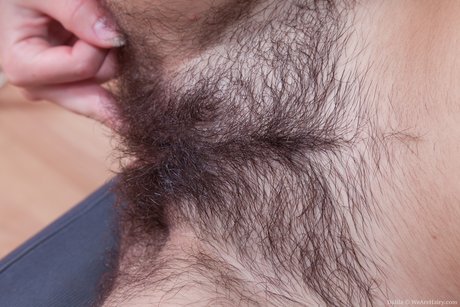 Dalila starts shameless masturbation of hairy pussy in her room