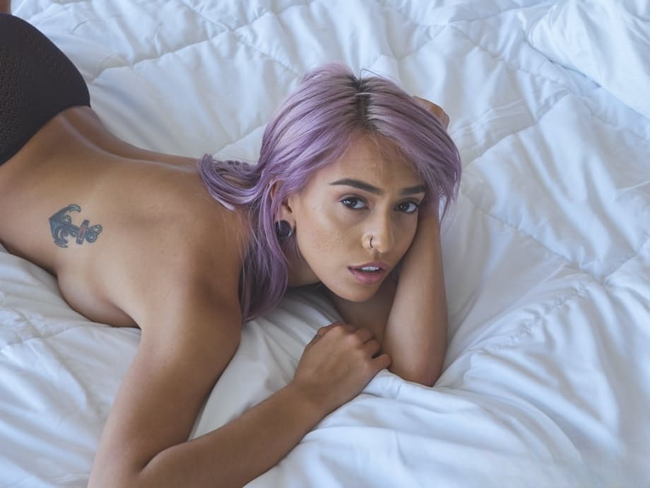 Solo girl Janice Griffith uncovers her firm breasts as she strips to her socks