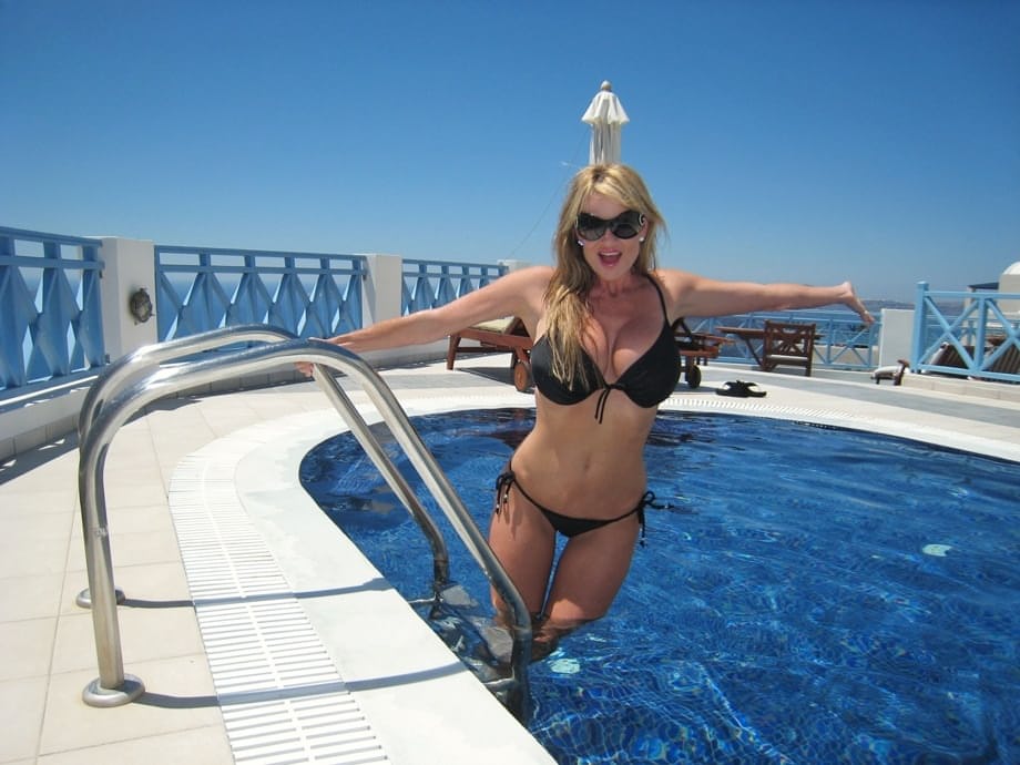 After tanning and relaxing by the beautiful pool, busty MILF sucks fat dick