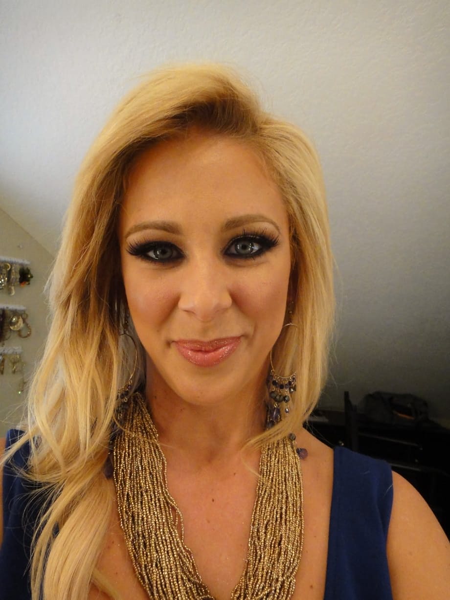 Curvy blonde pornstar Cherie Deville reveals her ass and fake tits