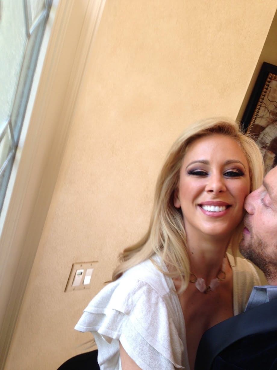Curvy blonde pornstar Cherie Deville reveals her ass and fake tits