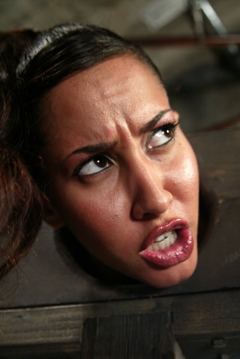 Isis Love finds herself being humiliated in the stocks with a hook in her anus