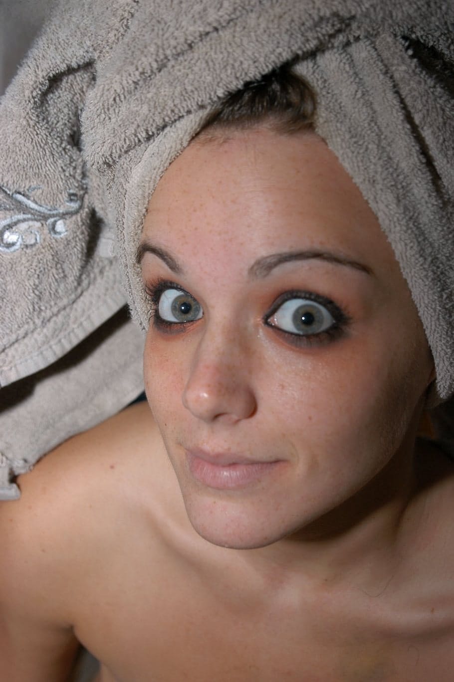 Big-eyed brunette girl flashes natural tits & hot naked ass upskirt
