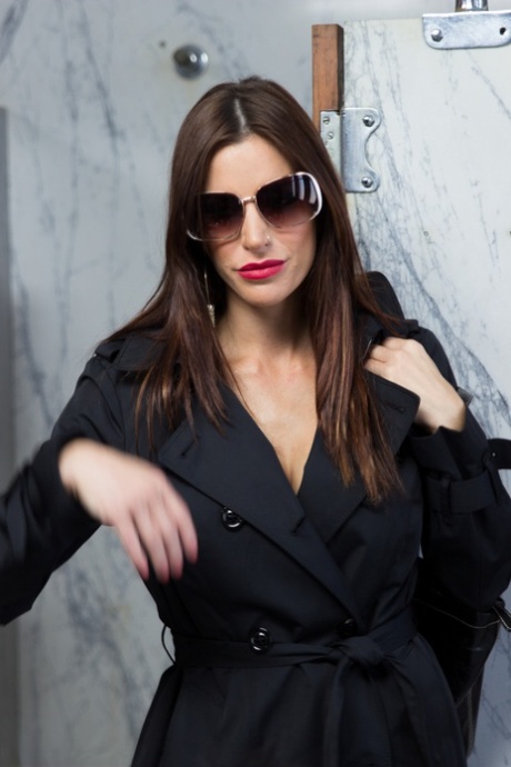 Smoking Gia DiMarco opens trench coat to sit on men's toilet in hot lingerie