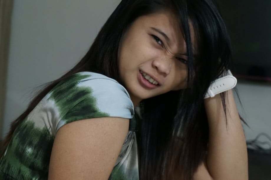 Cute Filipina teen gives a blowjob attired in a Santa Claus cap