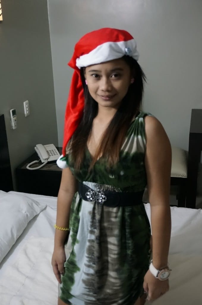 Cute Filipina teen gives a blowjob attired in a Santa Claus cap