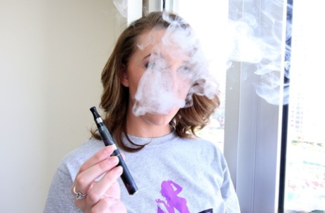 Busty Brooke Wylde plays with her amazing natural tits after smoking an e-cig
