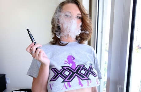 Busty Brooke Wylde plays with her amazing natural tits after smoking an e-cig