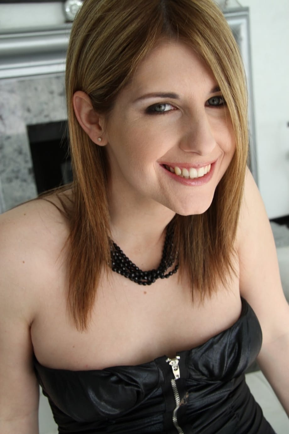 Sweet looking transsexual Amy Daly reveals her fine cock at home