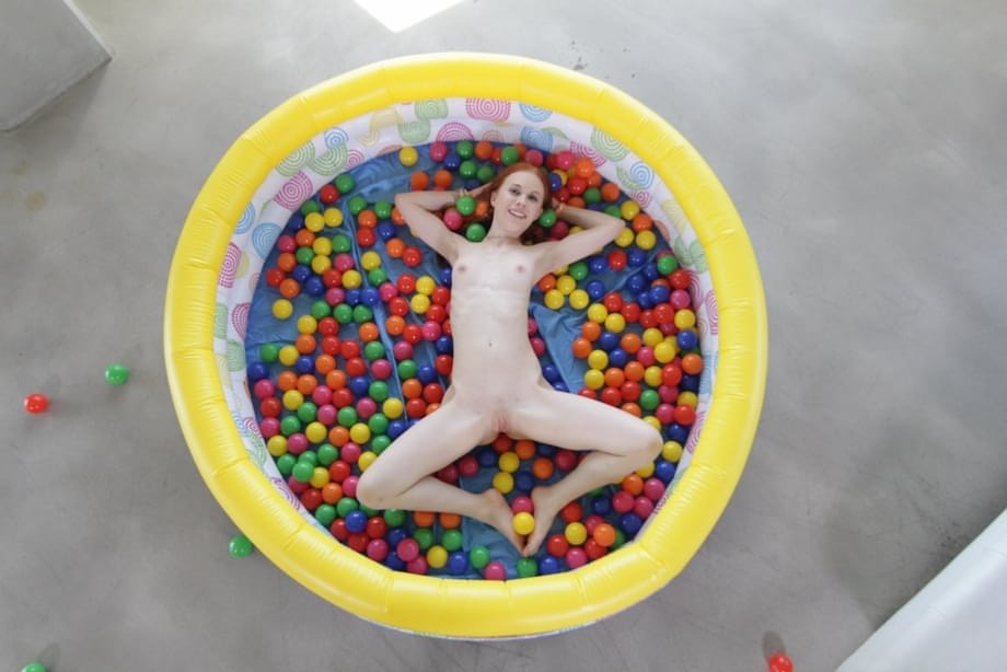 Pigtailed redhead Dolly Little uncovers tiny tits & spreads nude while playing