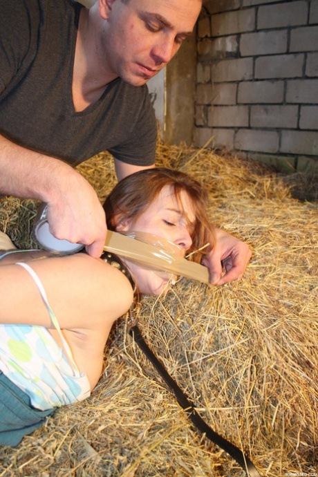 Naughty pantiless teen Anouk bound with rope & gagged with tape in the barn