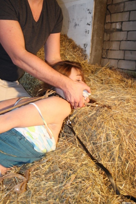 Naughty pantiless teen Anouk bound with rope & gagged with tape in the barn