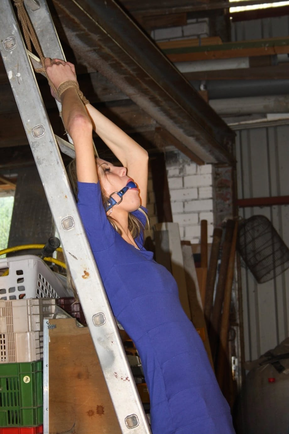 Amateur blonde Irena gagged & tied fully clothed to a ladder for garage grope