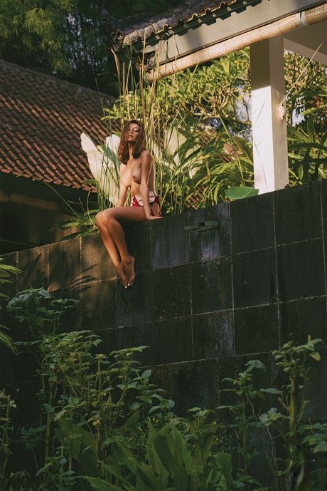 Romanian model Raluca Cojocaru posing and waling butt naked through jungle